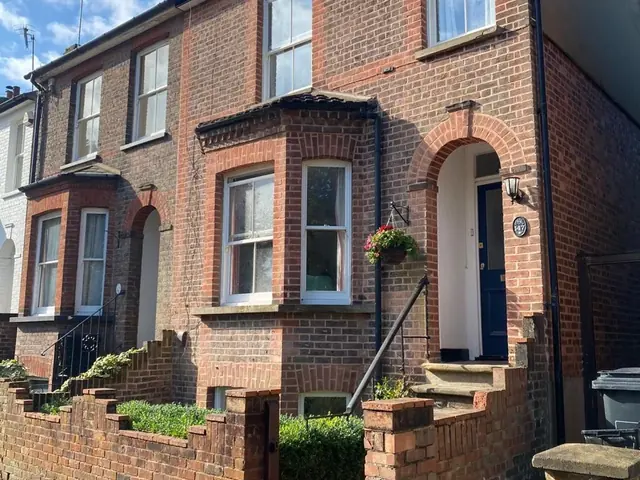 Victorian red brick house after repointing, viewed from the street.