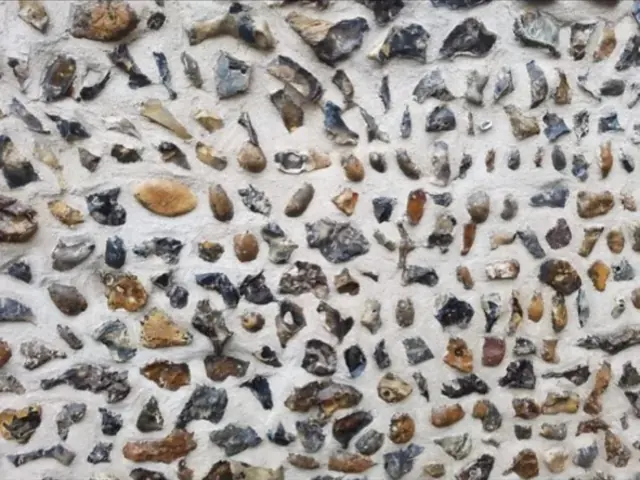 Close view of a newly pointed flint wall.