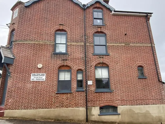 Tall red brick gable elevation after extensive repointing.