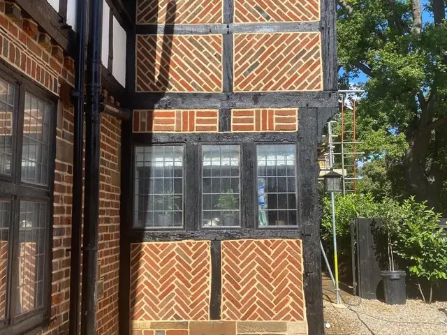 Restored decorative timber framed bay with herringbone brick infill.