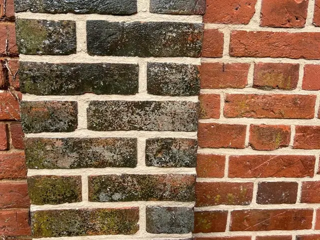 Side by side comparison of weathered dark joints and renewed red brick pointing.
