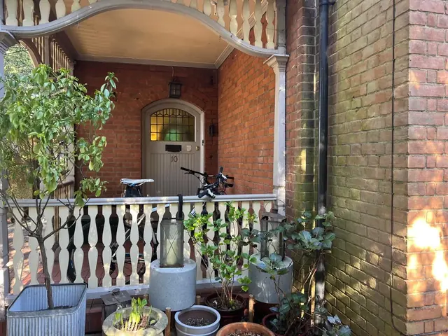 Covered brick entrance porch before repair and redecorating.