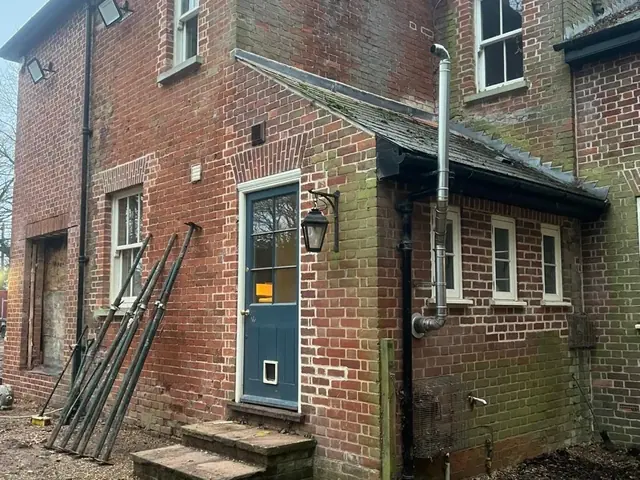 Rear and side elevations of a period lodge before brick cleaning and repointing.