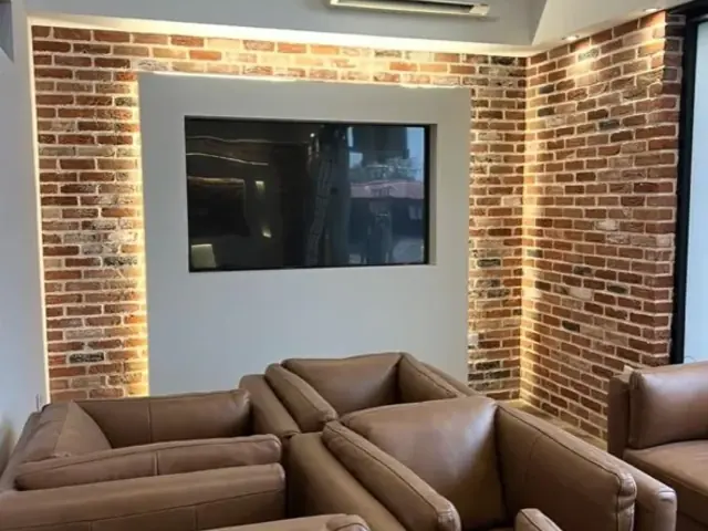 Completed interior seating area with illuminated exposed brick walls.
