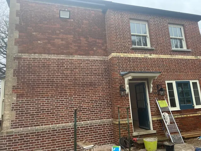 Side elevation of a period lodge with completed red brick repointing.