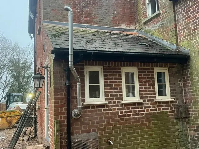 Single storey brick wing before cleaning and repointing.